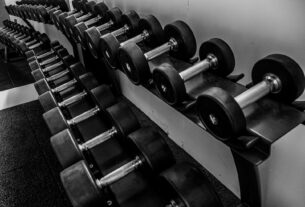 black and silver dumbbells on black steel rack